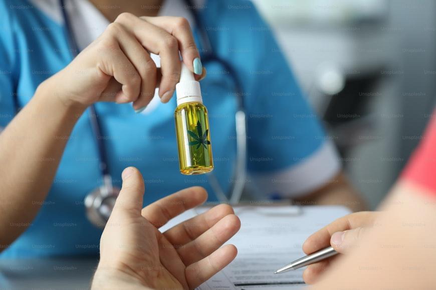 doctor handing cannabis oil to patient