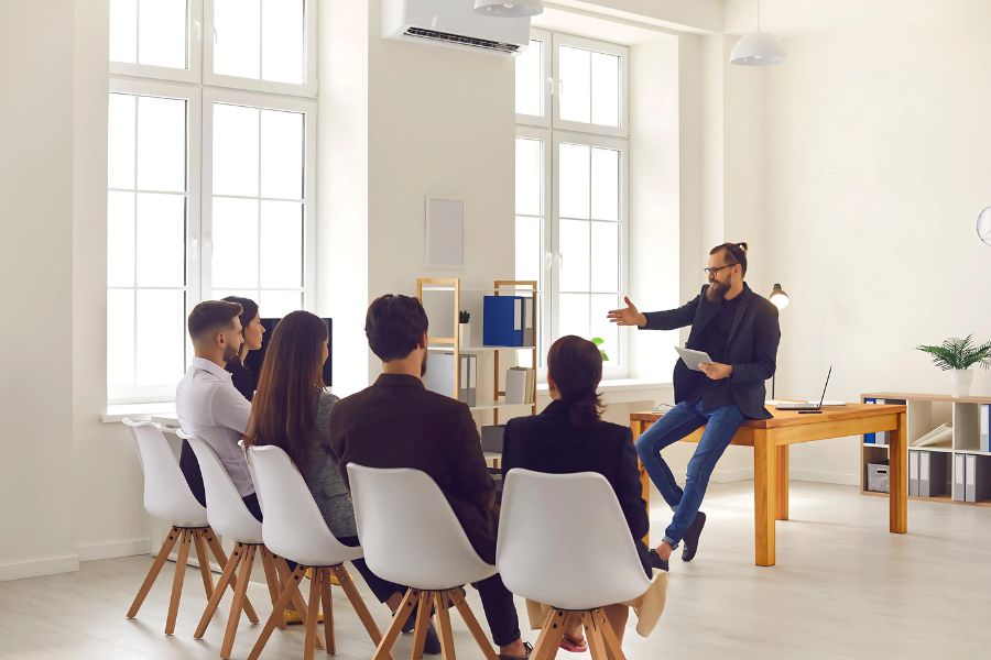 Group of people listening to a presenter in a bright conference room