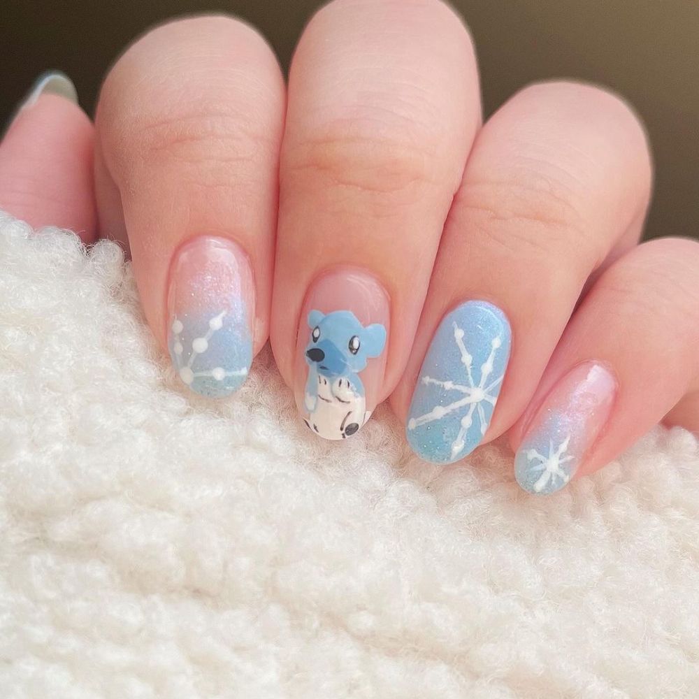 Close up of hands with blue winter nails having Cute Nail art for winter