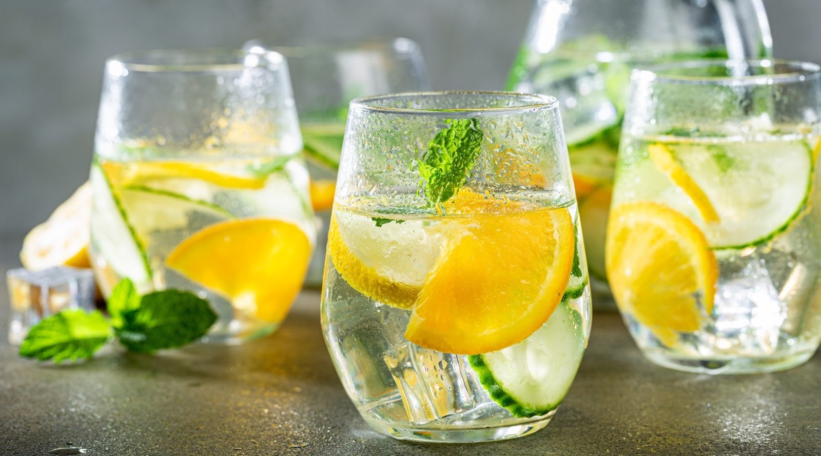 Glasses of water with orange, cucumber, and mint, a refreshing choice at a healthy restaurant near Ontario dietitian.