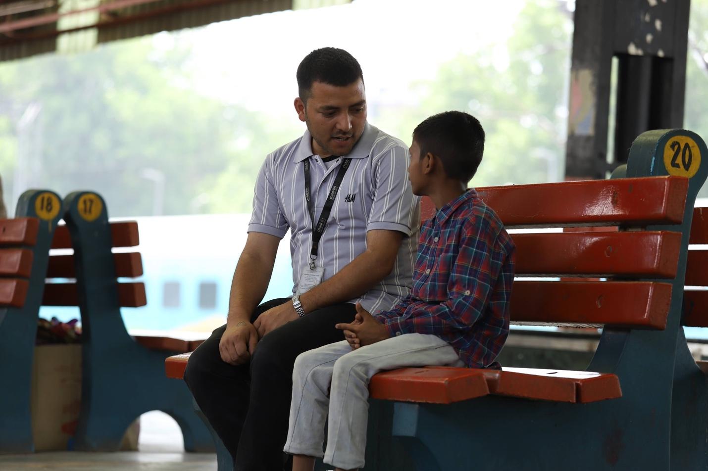 A person and child sitting on a bench

Description automatically generated