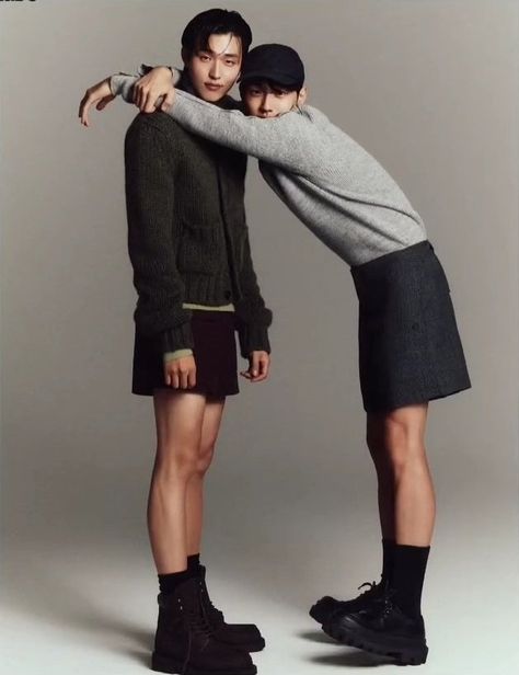 This  contain an image of LGBT K-Drama Jin Ho Eun and Nam Yoon Su standing next to each other in front of a gray background, one wearing black boots