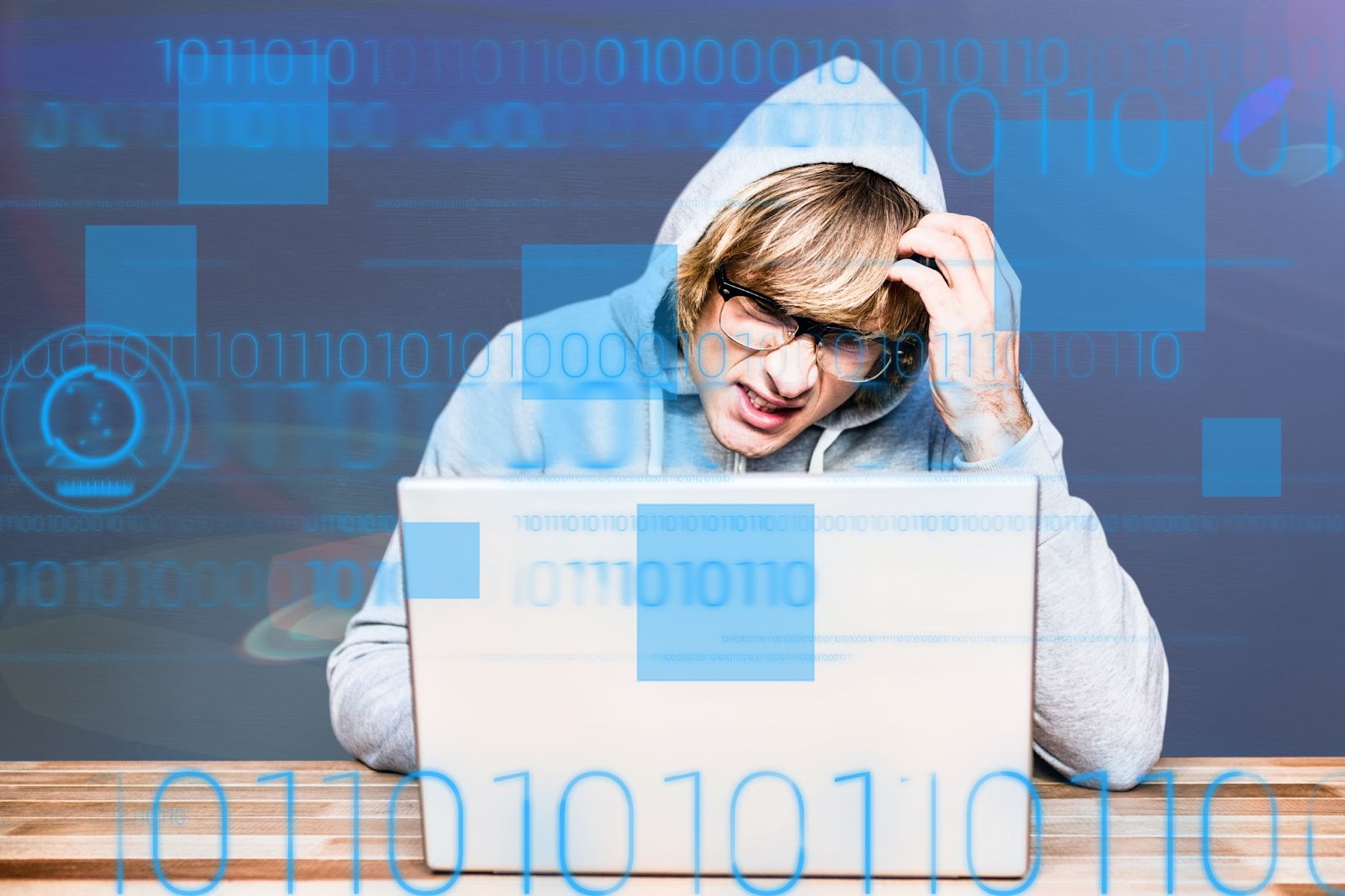 Young man in hoodie, puzzled while working on a laptop with digital code overlay