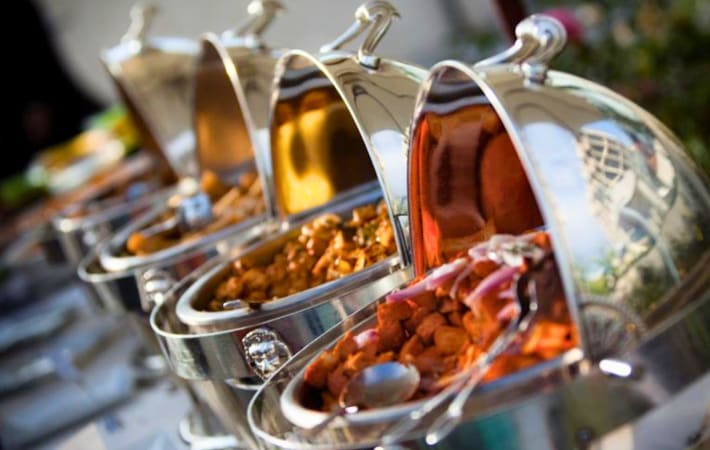 Chafing dishes serving up different curries.