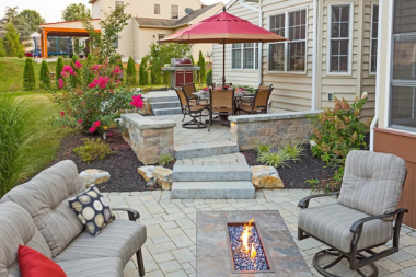 fire pit area designs for your northern michigan backyard multi level entertainment zone with stone steps and dining area custom built boyne city