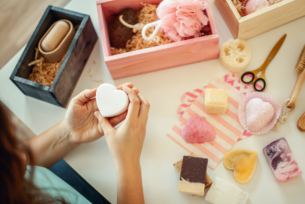 Woman choosing different soaps and body care products for a gift basket