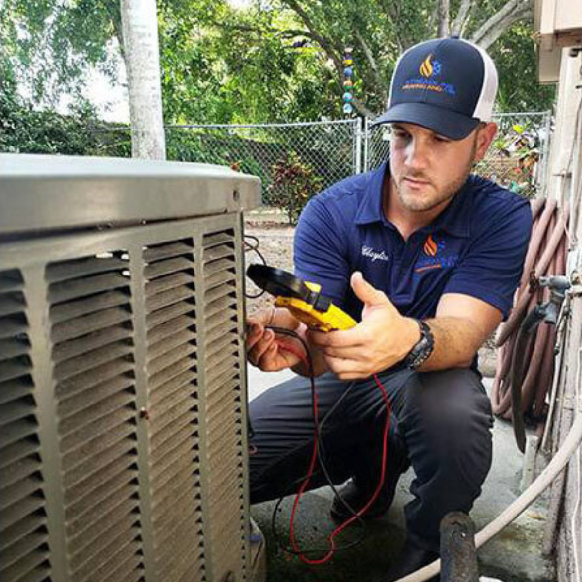 A Streamline Heating and Air technician working on an outdoor HVAC unit