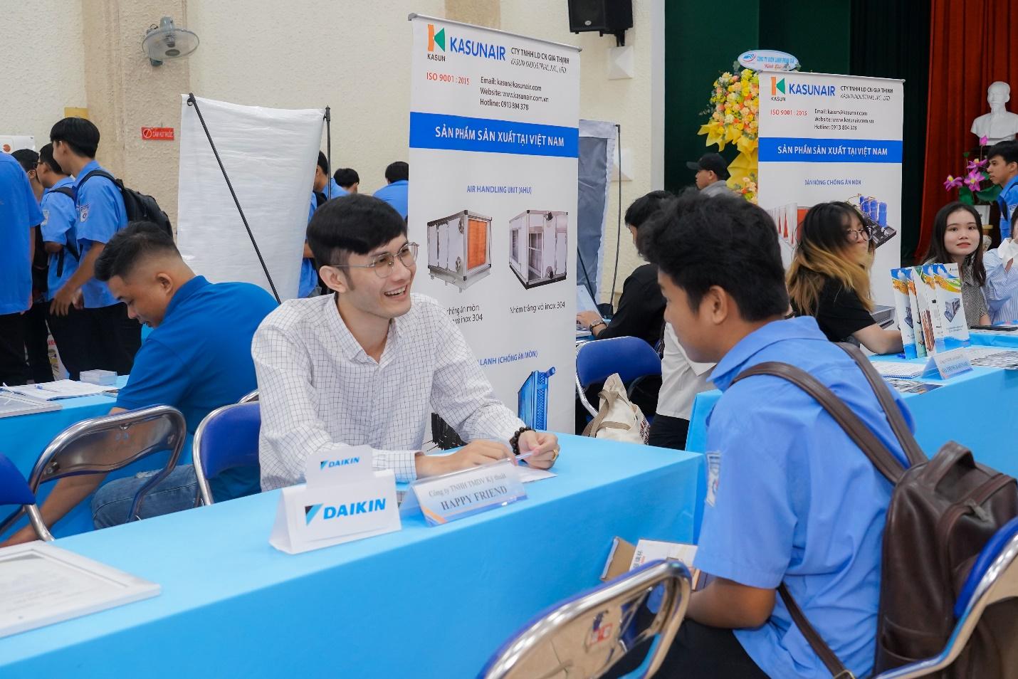 A person sitting at a table with a signDescription automatically generated