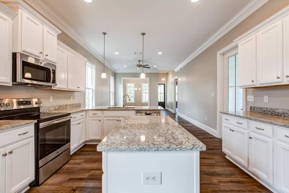 The kitchen includes a center island with a granite countertop.