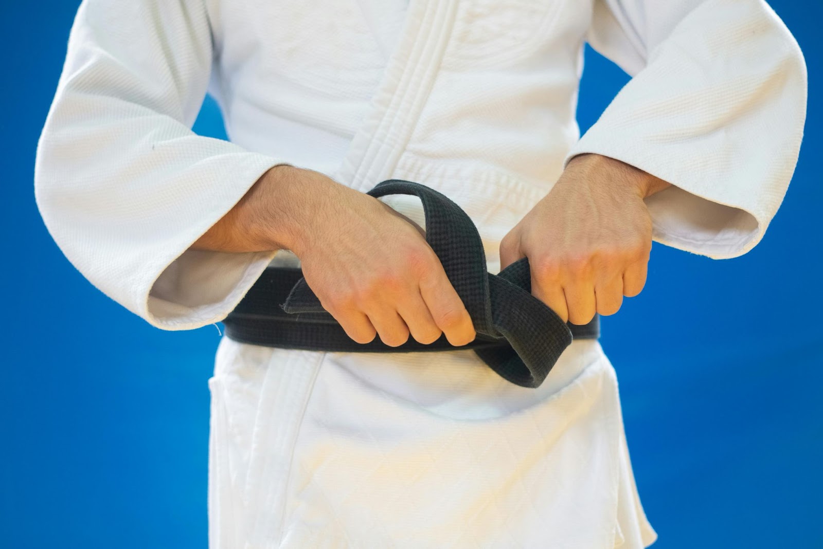 A martial arts student wearing a black belt