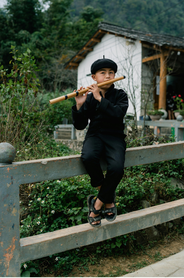 ethnic boy blowing flute in Ha Giang