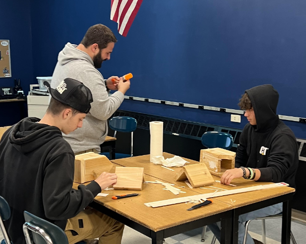 image of students working on building a birdhouse