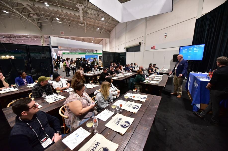 A group of people sitting at tables

Description automatically generated