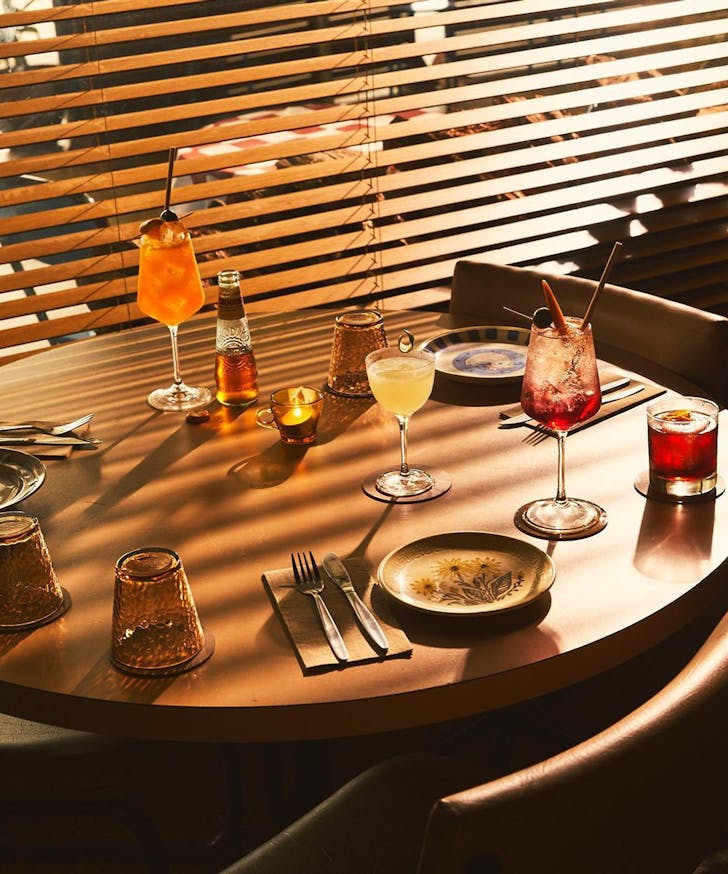 a bar loaded with cocktails in the sunlight