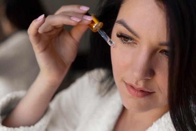 woman applying face serum close up, Picture
