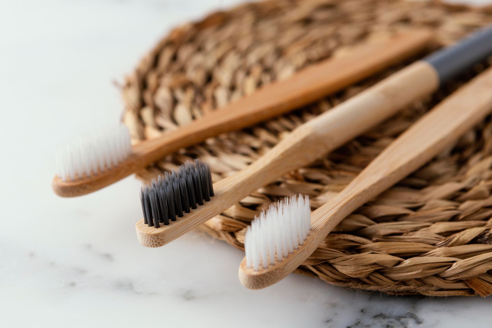 Bamboo toothbrushes as alternatives to plastic equivalents.