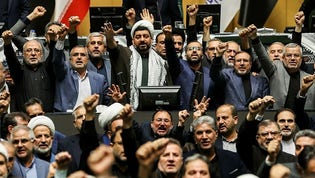 Members of Iran's parliament shout anti-Israeli slogans on Sunday, after Hezbollah leader Hassan Nasrallah was killed in an Israeli airstrike in Beirut.