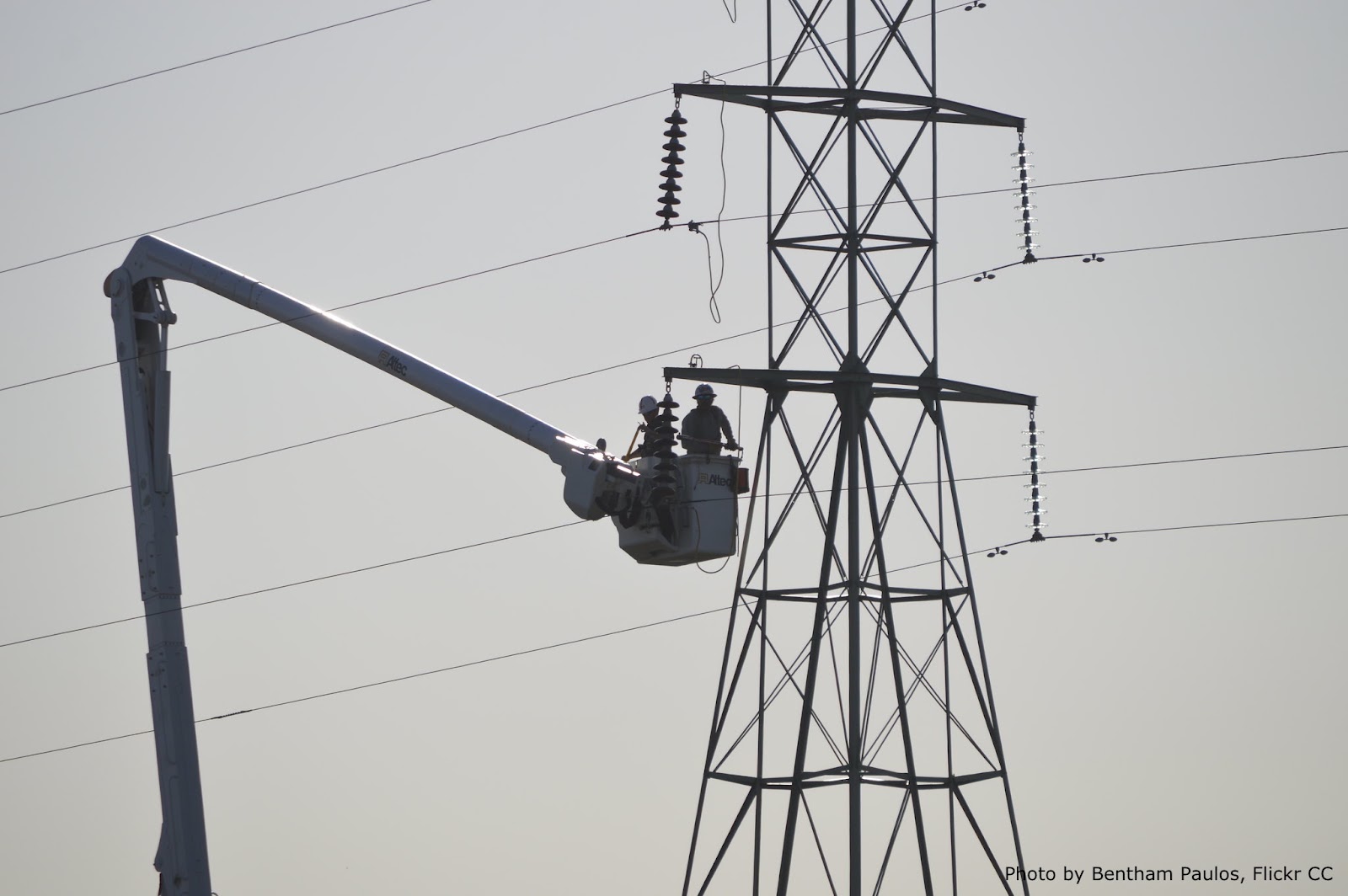 Utility Worker Does Repairs On Electrical Wires From A Cherry Picker