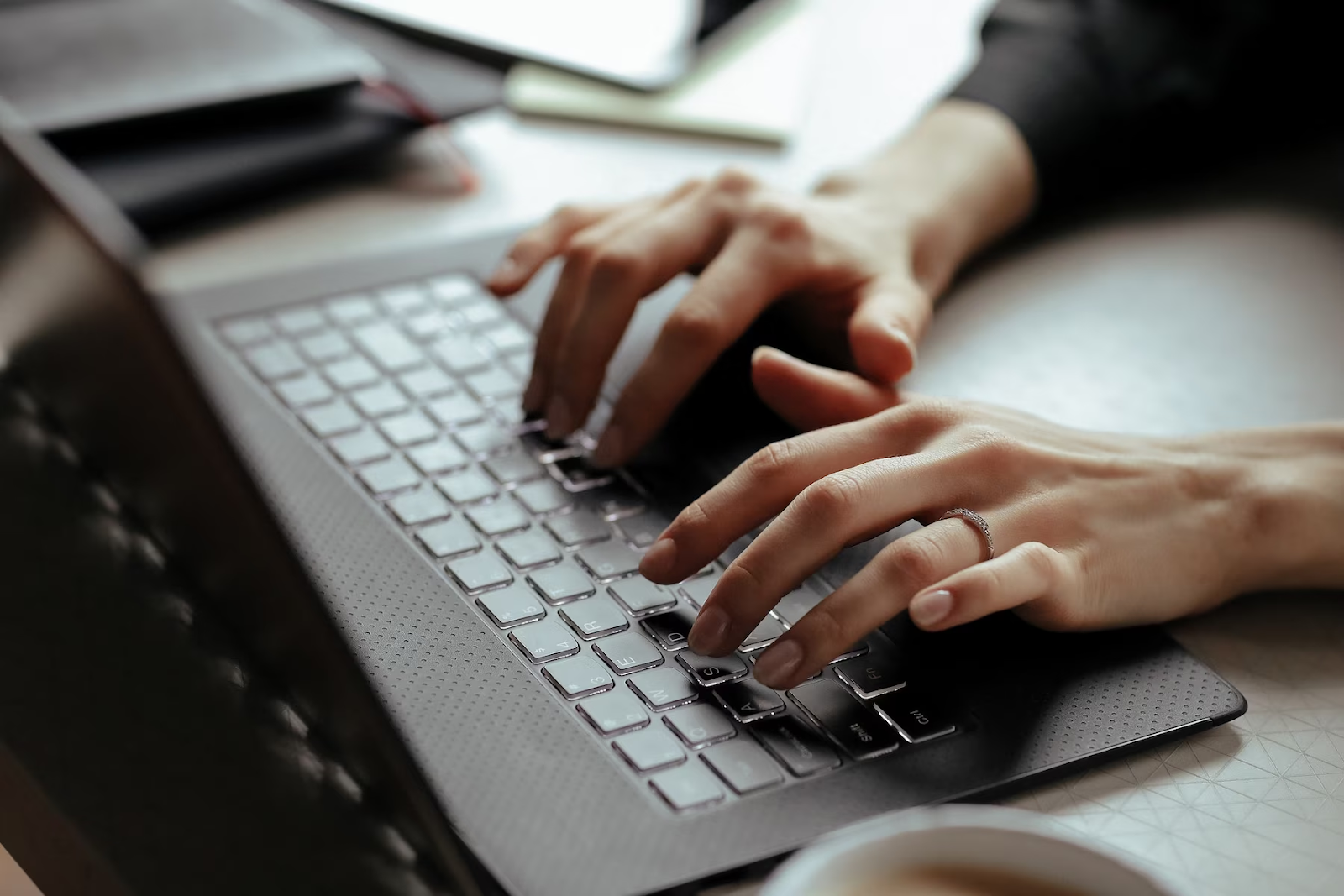 Close-up of hands typing on a laptop keyboard, perhaps drafting career advice.