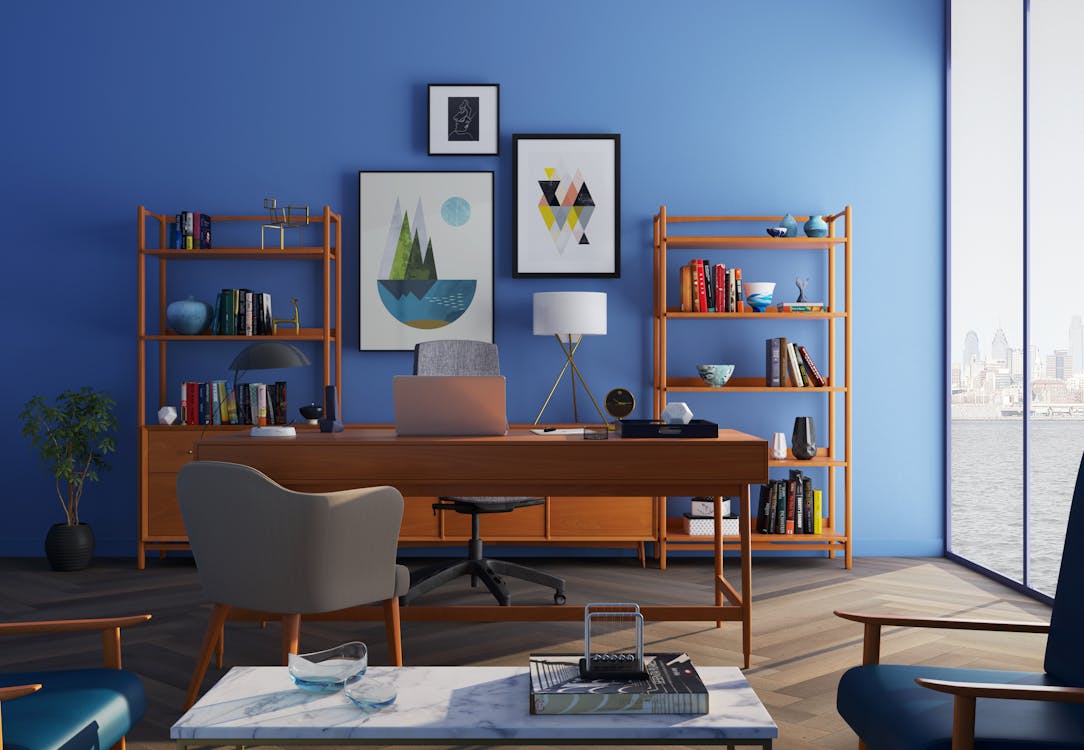 Free Elegantly decorated home office with modern furniture and a blue wall. Stock Photo