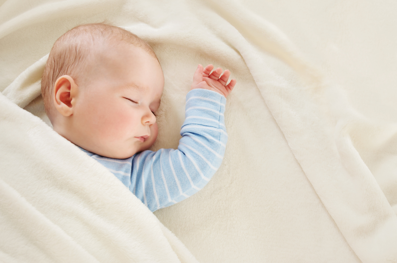 Baby sleeping under blanket // Healthier Baby Today