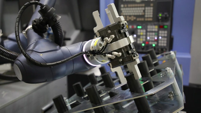 A picture of a cobot with a proprietary hand operating.