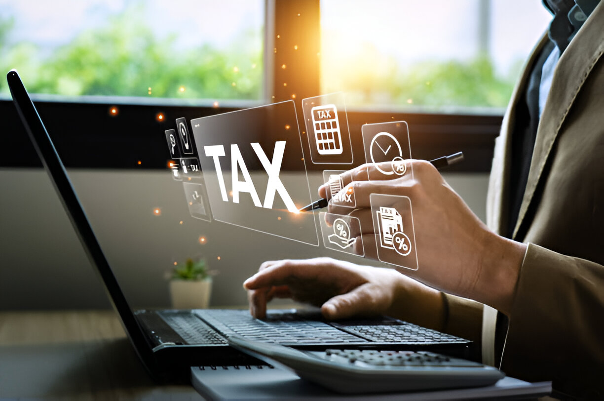 Person working on a laptop with digital tax icons, illustrating how bookkeeping simplifies tax returns and financial management.