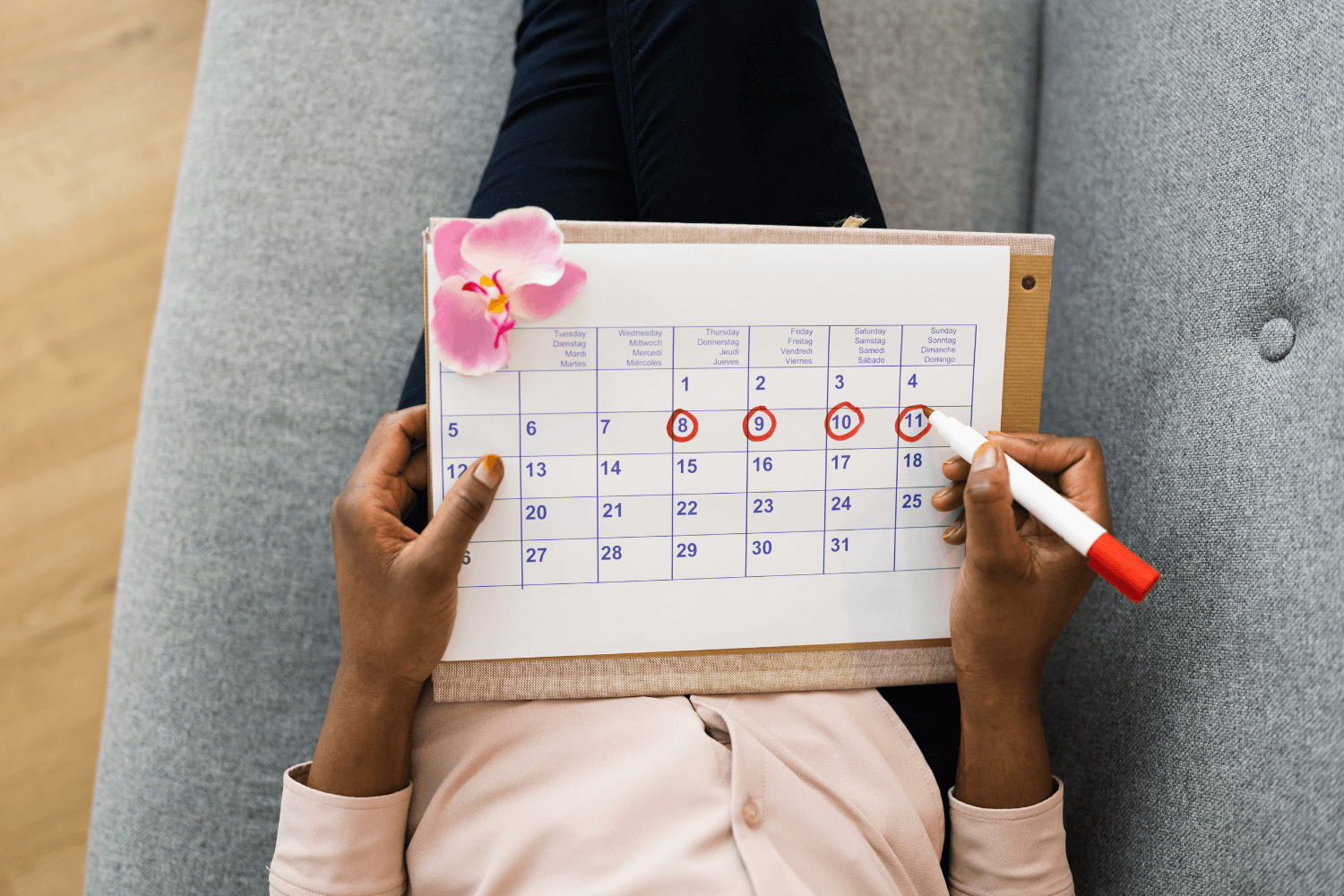 woman holding a calendar to track her menstrual cycle