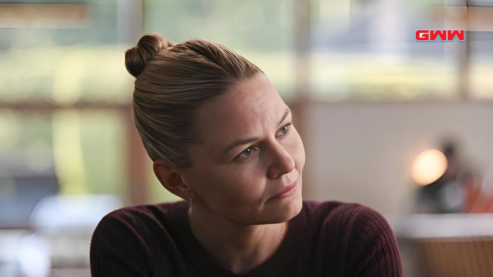 Yael Grobglas sitting in a cafe, contemplative, "Tracker" show