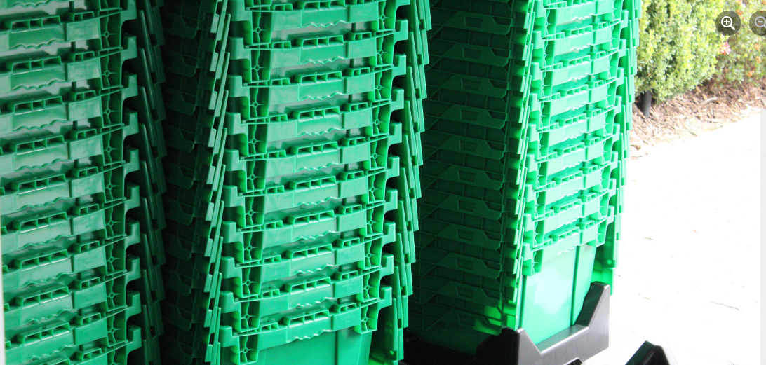 A stack of green plastic crates

Description automatically generated