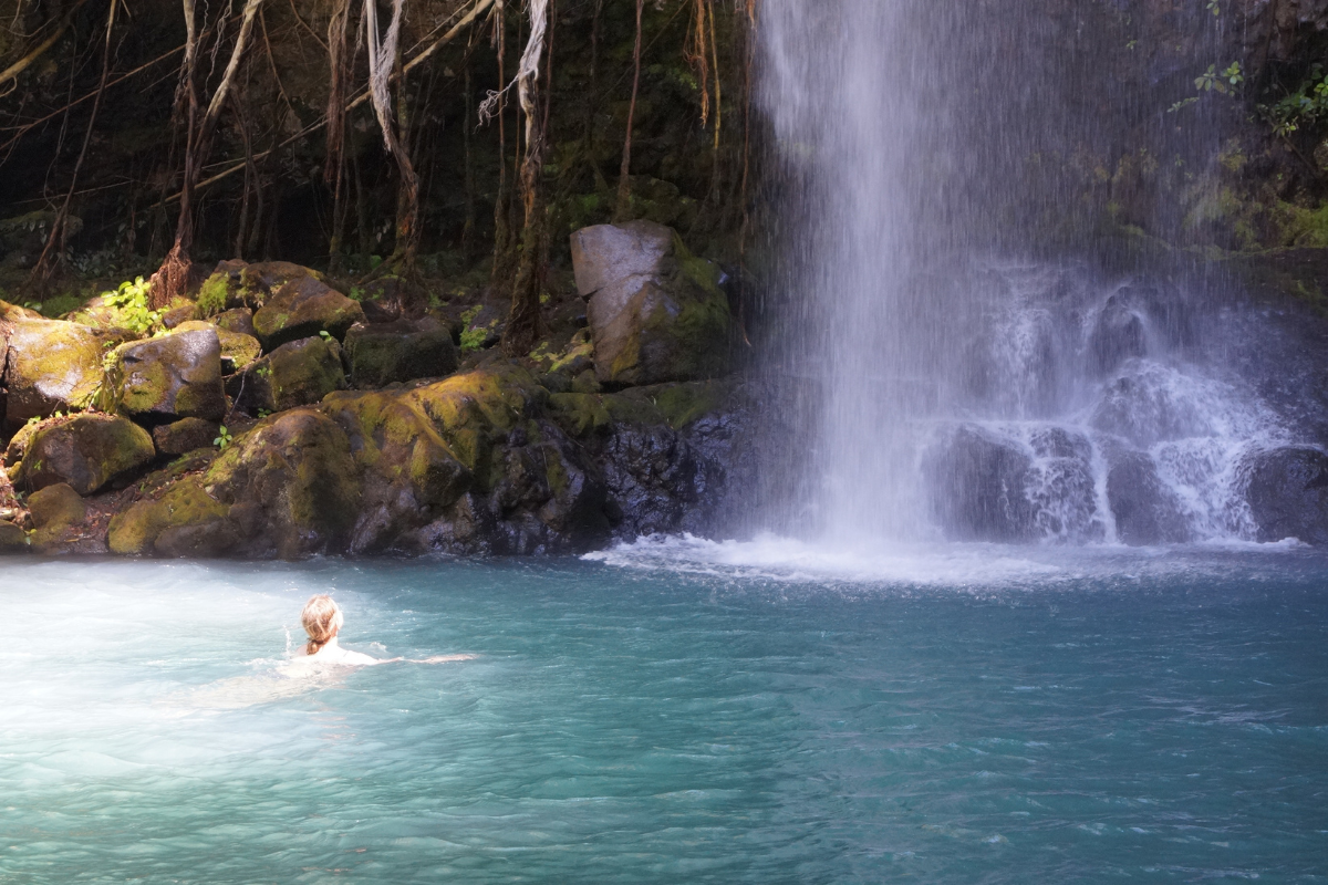 A woman swimming in La Cangreja Waterfall 
