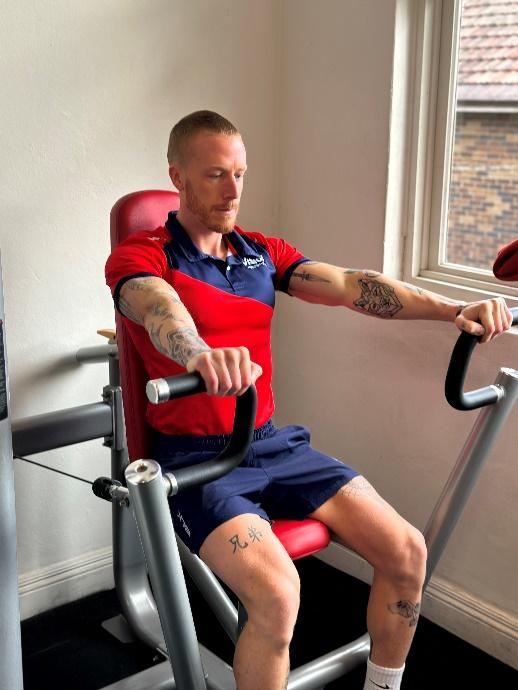 a Vision PT personal trainer using the chest press machine