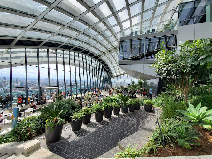 Panoramic view from the Sky Garden in London, showcasing stunning cityscapes and lush greenery at the top of the building