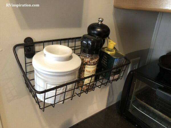 Storage basket mounted on RV wall