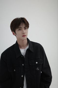 This contain an image of Yanan putting on black suit and white inner shirt