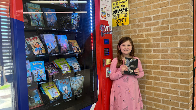 Satisfied child with Inchy's Bookworm Vending Machine