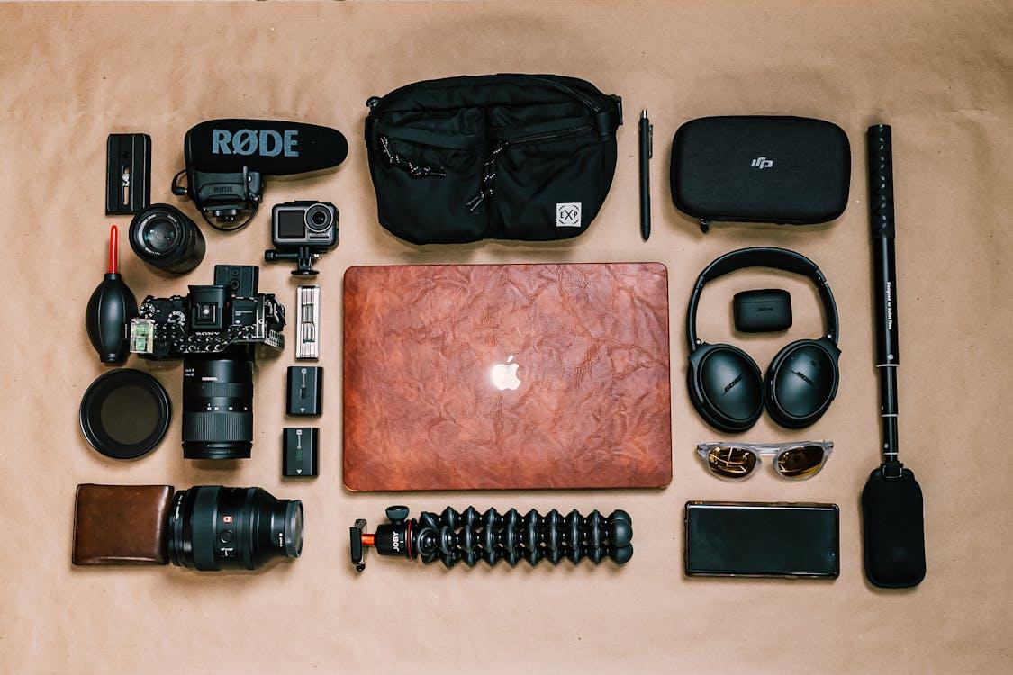 Free Overhead view of laptop and photo camera composed with headphones and other gadgets of professional photographer Stock Photo