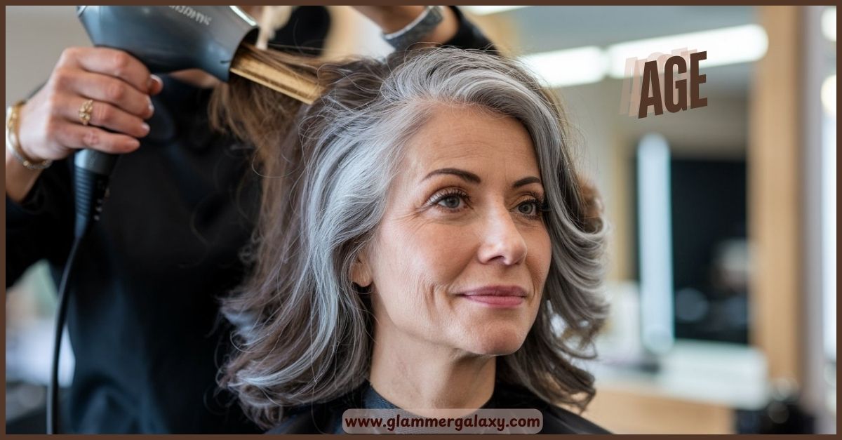 Person getting hair styled with dryer, gray hair visible