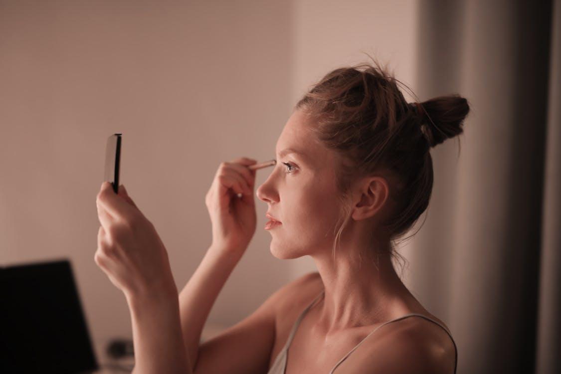 Free Woman Putting Makeup on Face Stock Photo