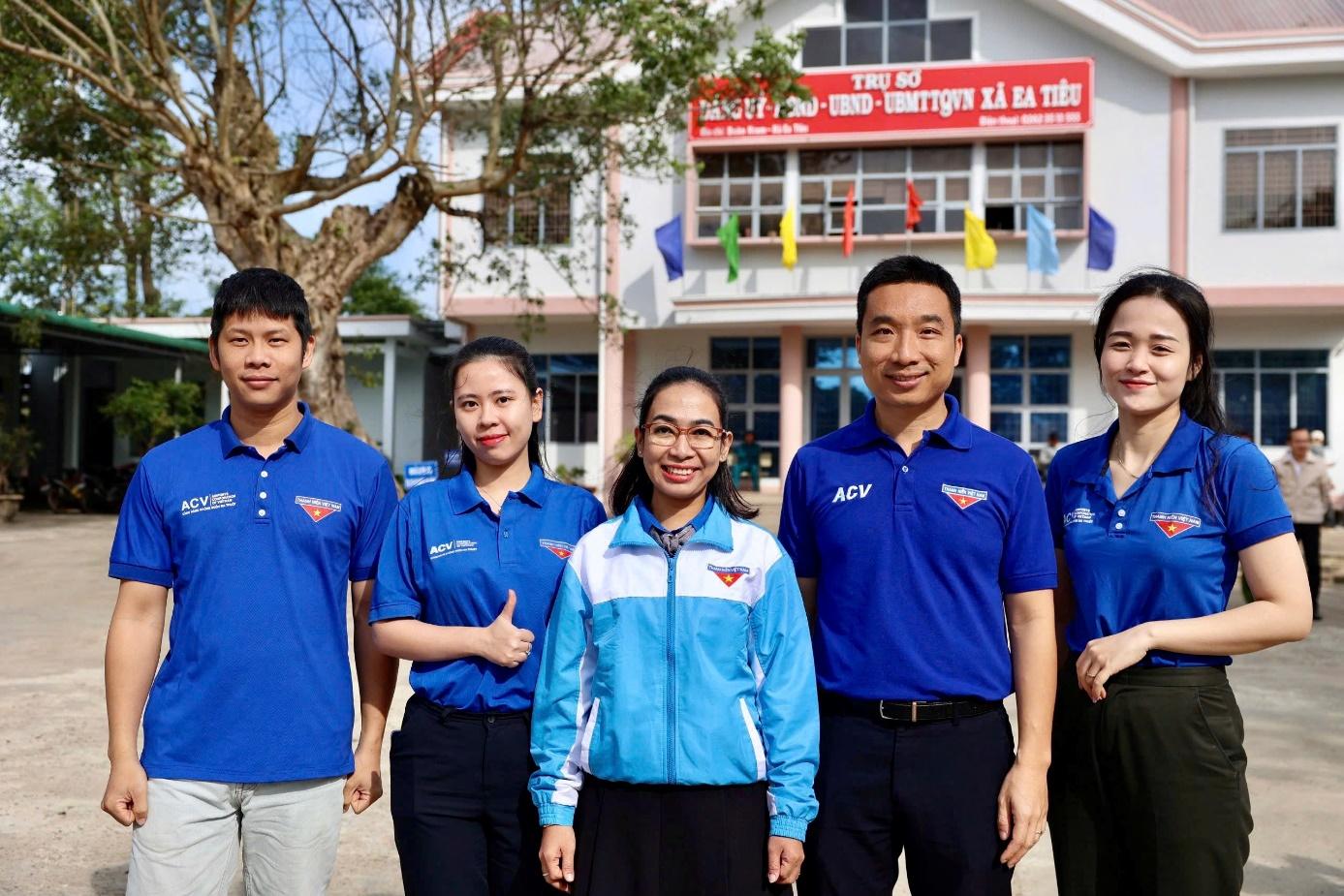 A group of people standing in front of a buildingDescription automatically generated