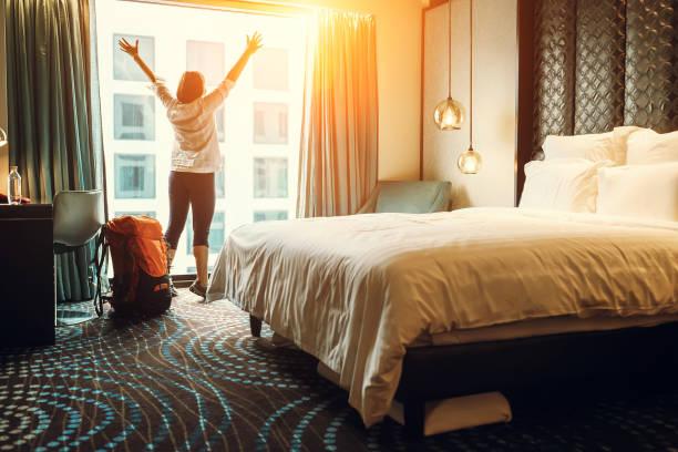 Happy backpacker traveller stay in high quality hotel Happy backpacker traveller stay in high quality hotel accomodation stock pictures, royalty-free photos & images