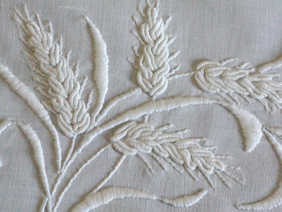 A close-up of a white embroidery

Description automatically generated