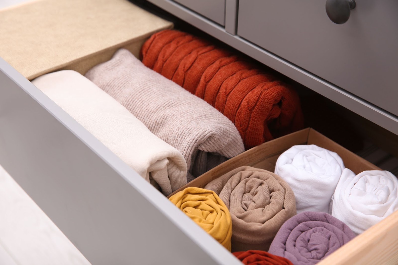 organized sweater in drawer both folded and rolled to best care for different types of materials