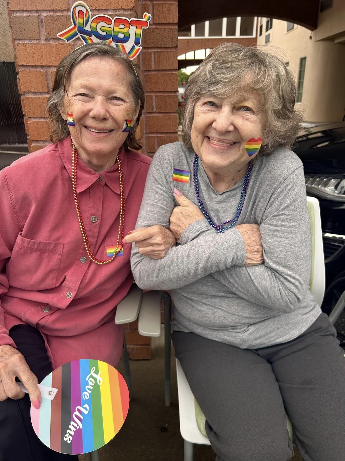 Two elderly women with arms linked