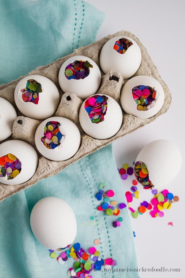 easter egg hunt ideas, cracked white eggs full of confetti, in an egg carton