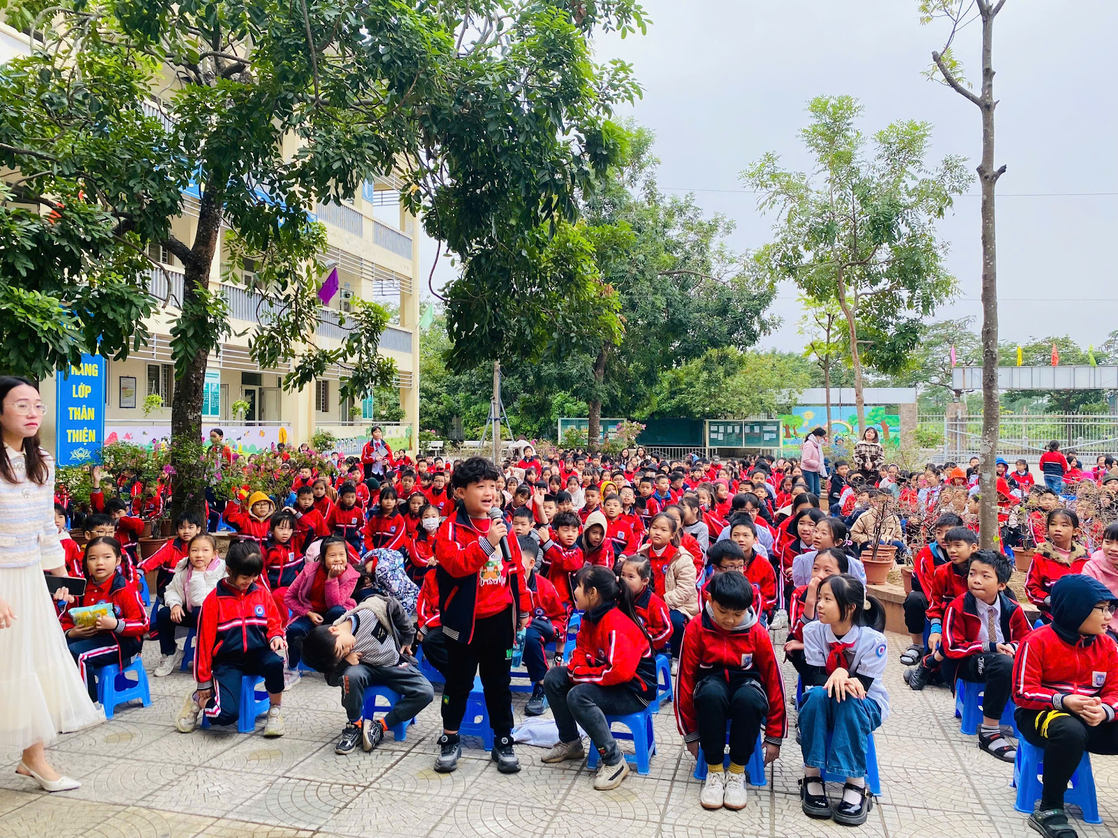 A group of children in red jackets

Description automatically generated