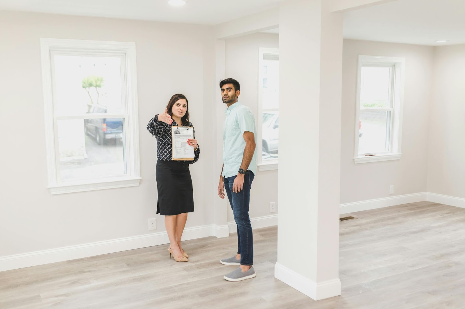 Realtor walking with client through empty home