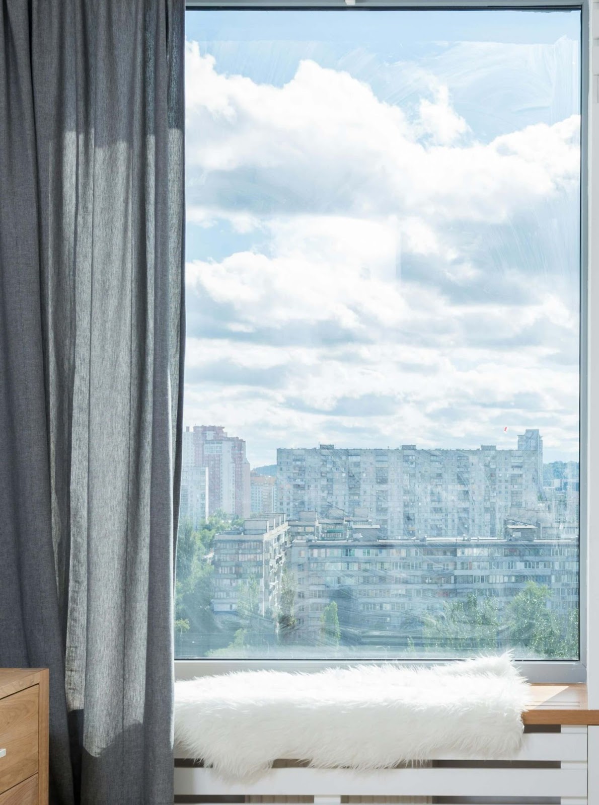 A picture window with a view of a city.