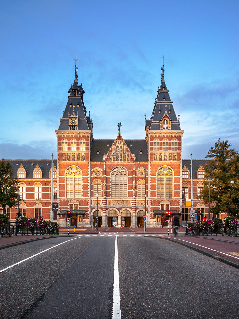 A large brick building with towers with Rijksmuseum in the background

Description automatically generated