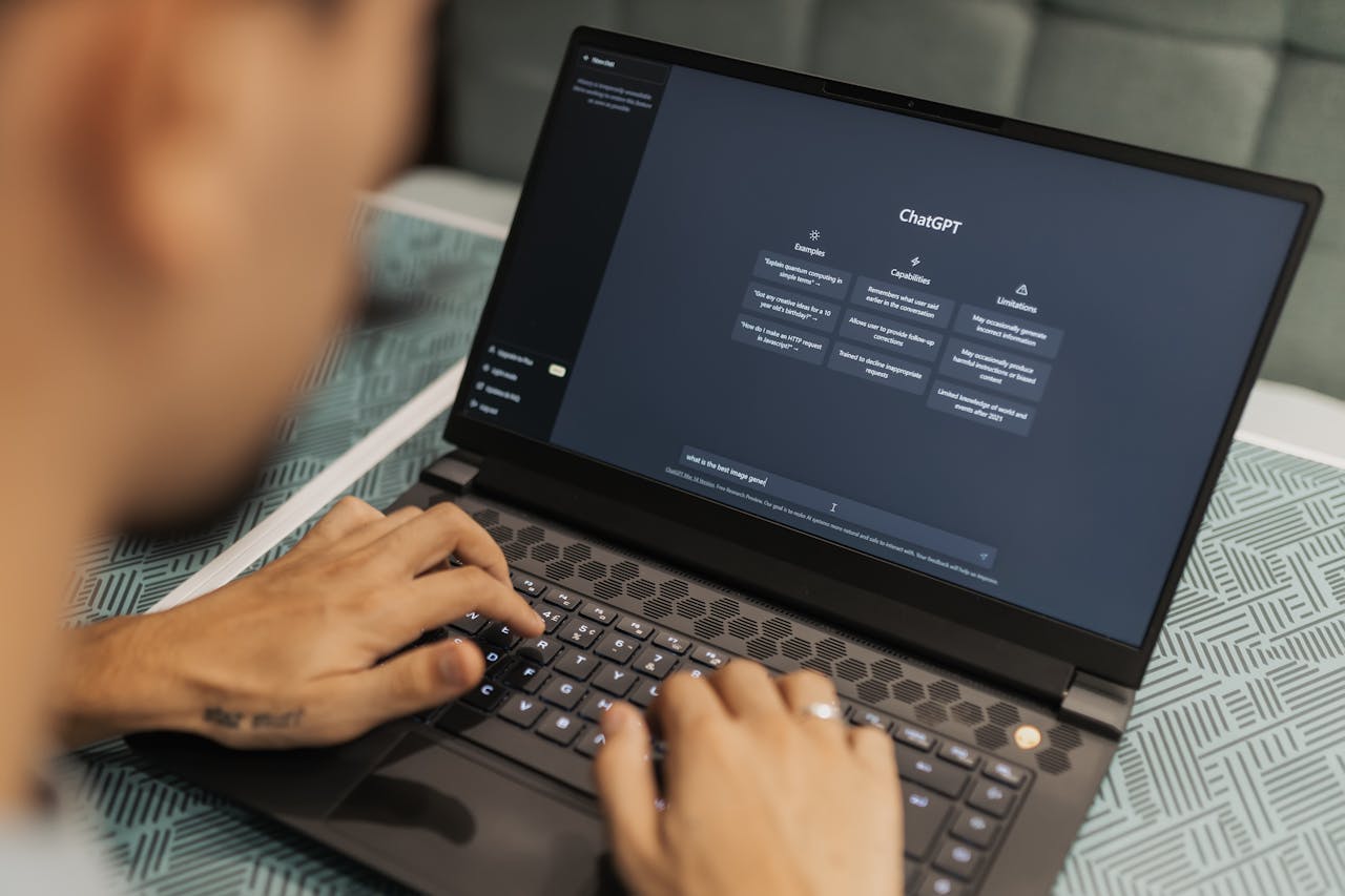 A person typing on a laptop displaying the ChatGPT interface, symbolizing the use of AI tools to enhance ecommerce business growth.